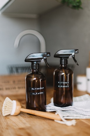 two brown spray bottles on brown table