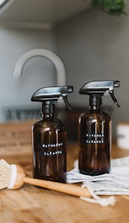 two brown spray bottles on brown table