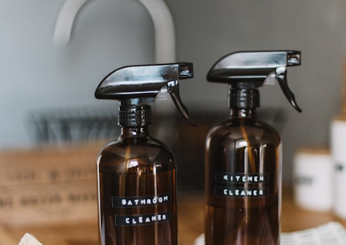 two brown spray bottles on brown table