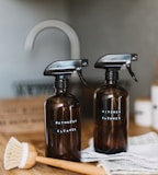 two brown spray bottles on brown table