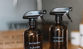 two brown spray bottles on brown table