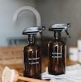 two brown spray bottles on brown table