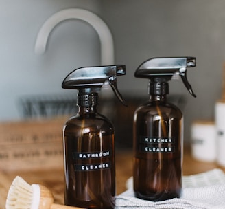 two brown spray bottles on brown table