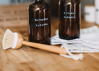 two brown spray bottles on brown table