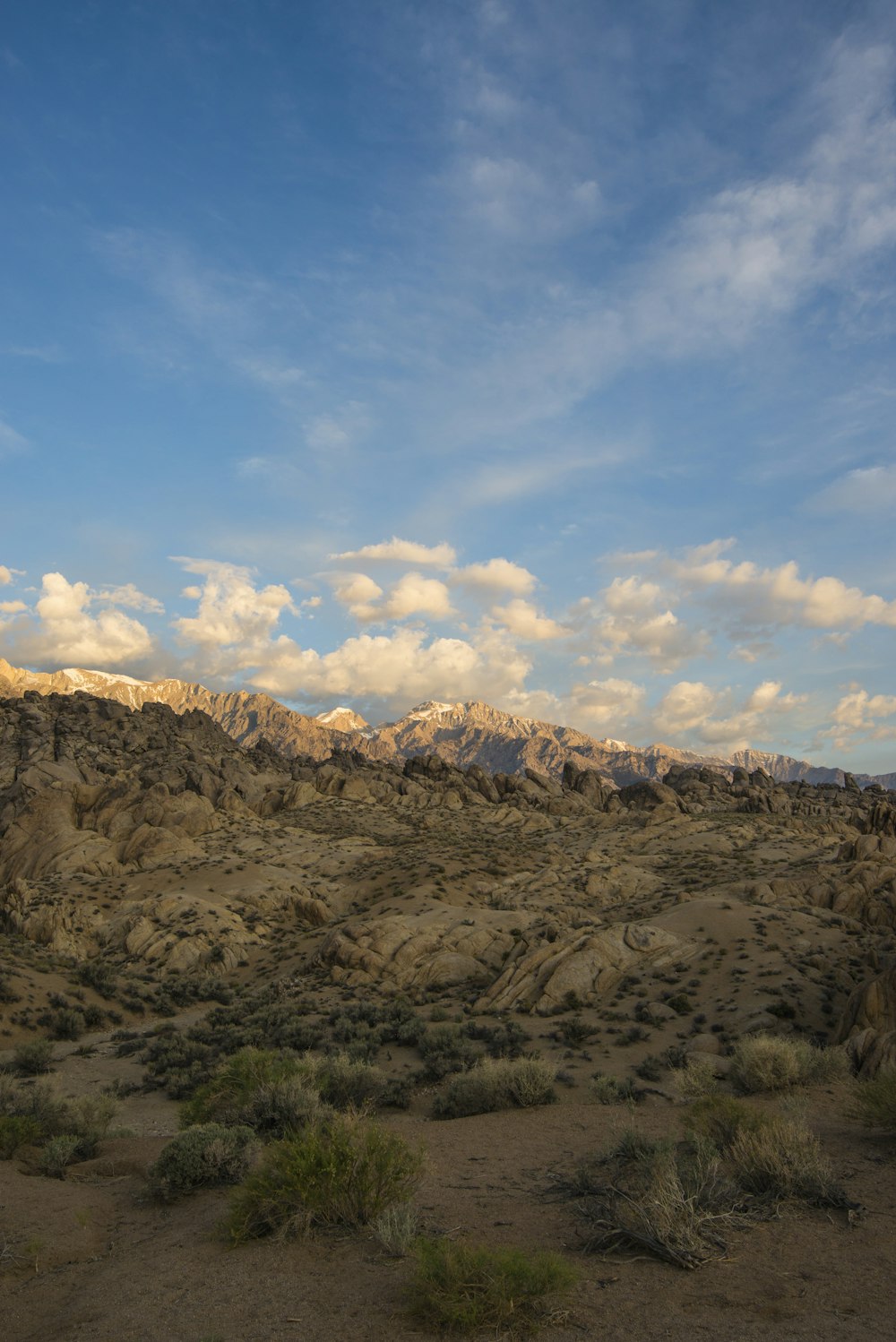 brown mountain under blue sky and white clouds during daytime