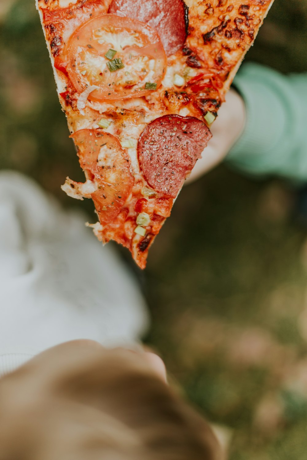 tomato and pepperoni pizza with cheese in selective focus photography