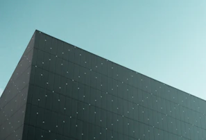 Minimalist architectural view of carbon capture equipment framed by dark sky and green accents.
