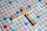 Wooden letter tiles spell out the words 'PROBATE' and 'LAWYER' on a Scrabble board. The board features a grid with colored squares marked with different point values such as 'Double Word Score' and 'Triple Letter Score'.
