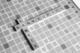 gray scale photography of Lawyer Bankruptcy scrabbles tiles