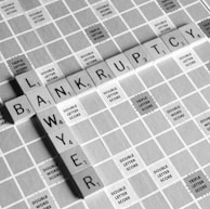 gray scale photography of Lawyer Bankruptcy scrabbles tiles