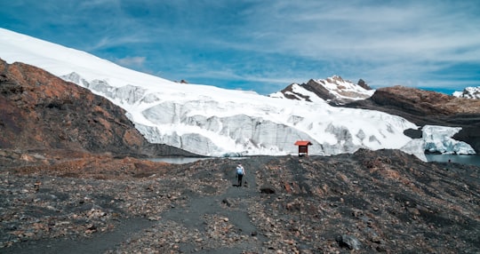 person walking at the hill during daytime in Pastoruri Glacier Peru