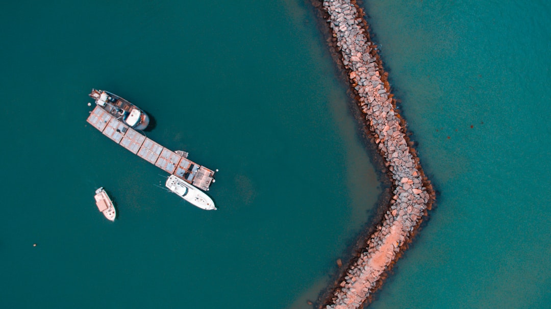 bird's eye view photography of boat near the coast