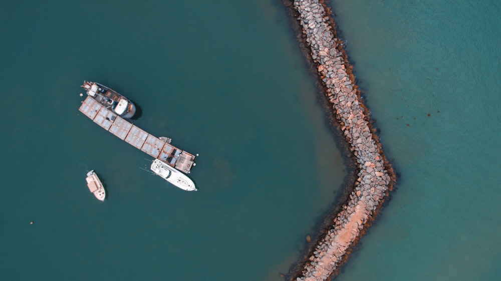 bird's eye view photography of boat near the coast