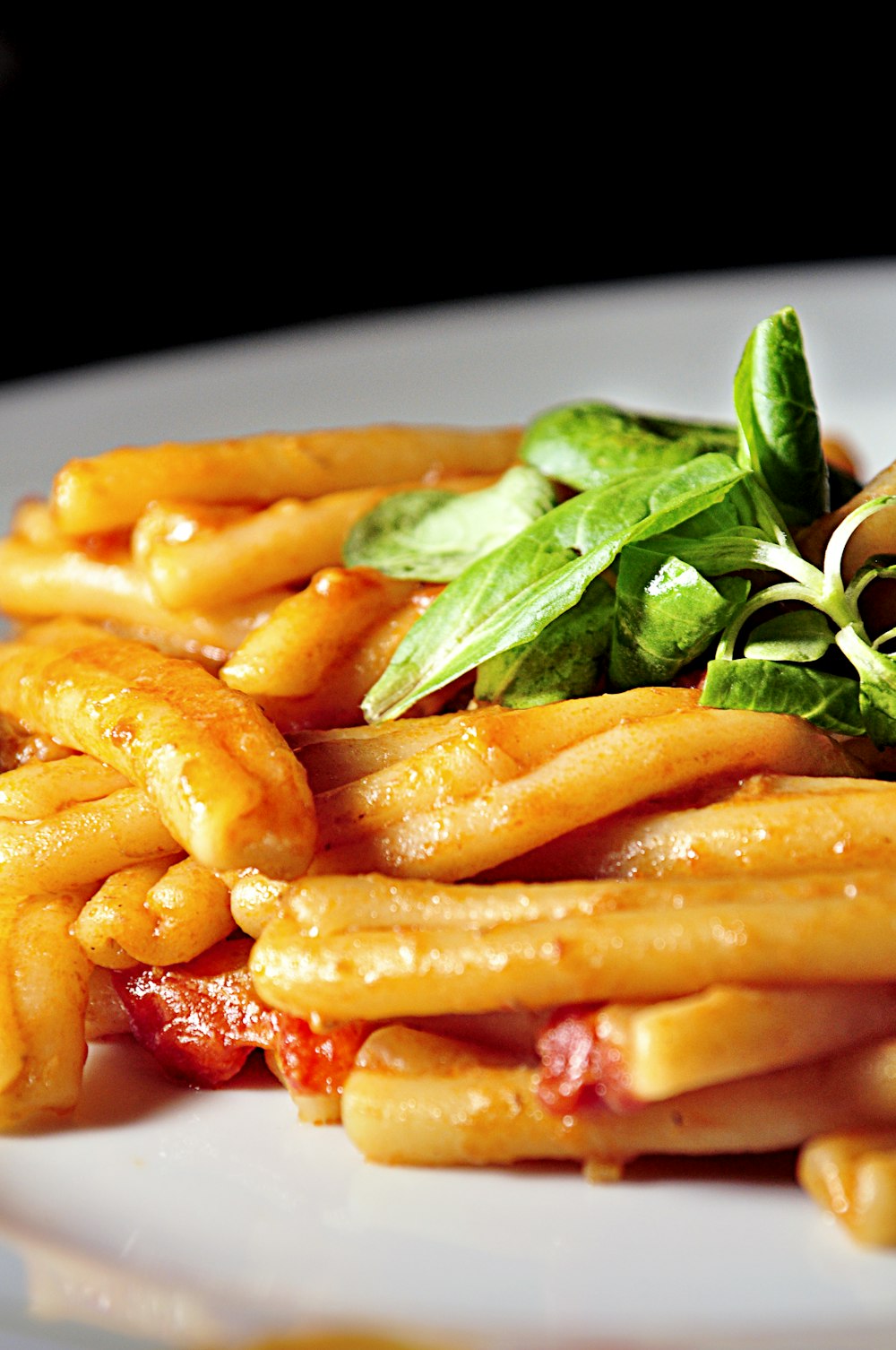 pasta with sauce and leafy greens