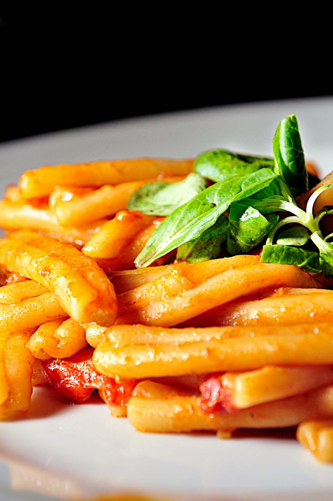 pasta with sauce and leafy greens
