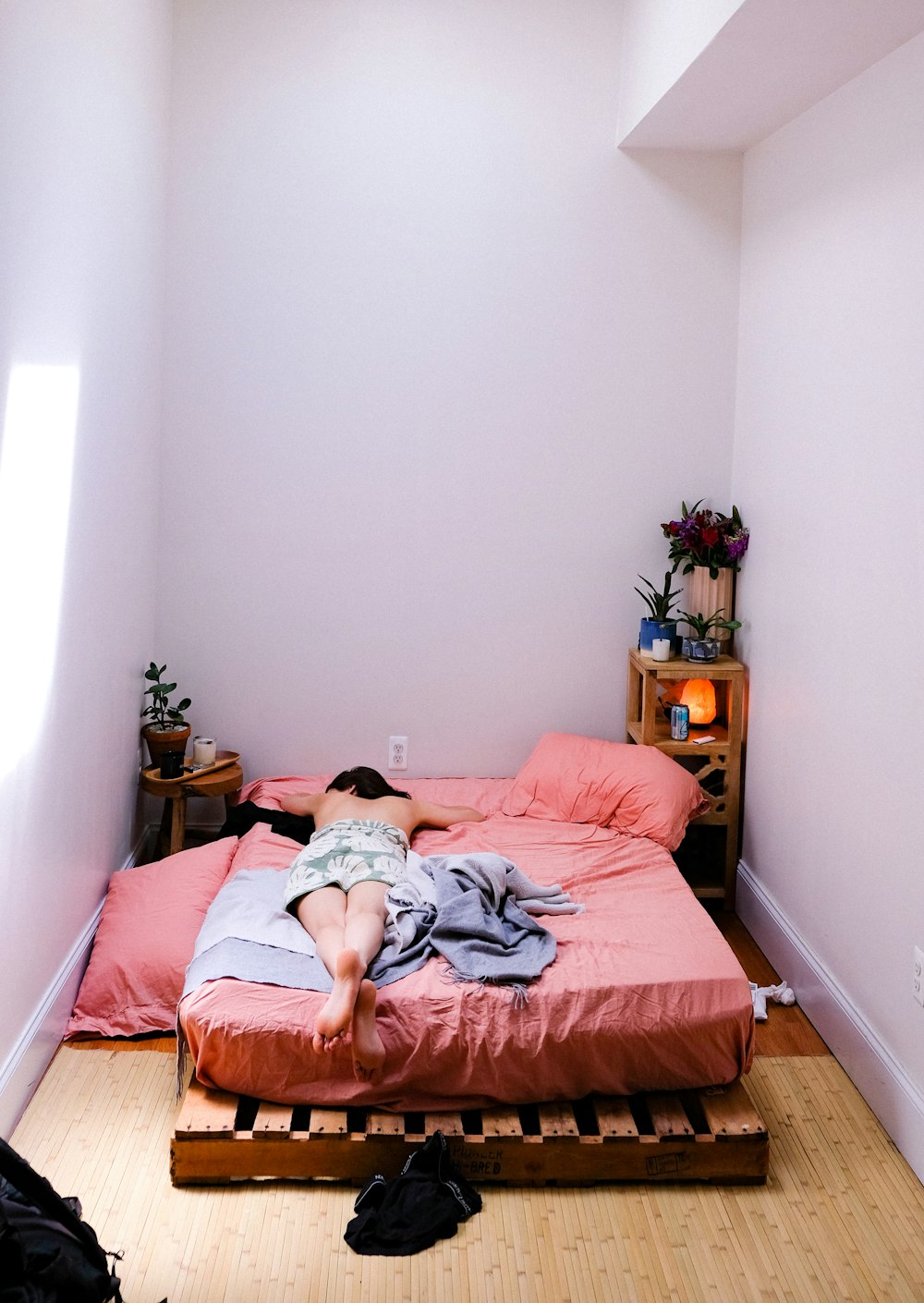 person lying on pink mattress