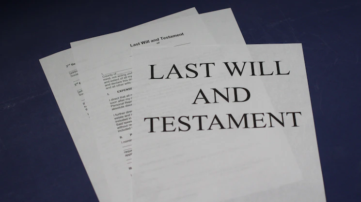 A stack of legal documents with a ktj legal consultancy branded pen resting on top.