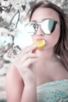 woman eating sliced orange fruit