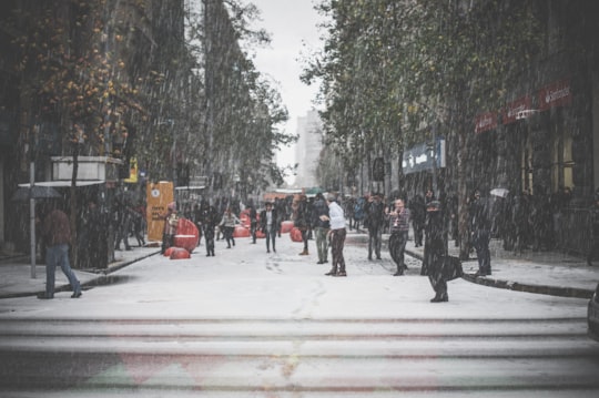 people walking on street during winter in Santiago Chile