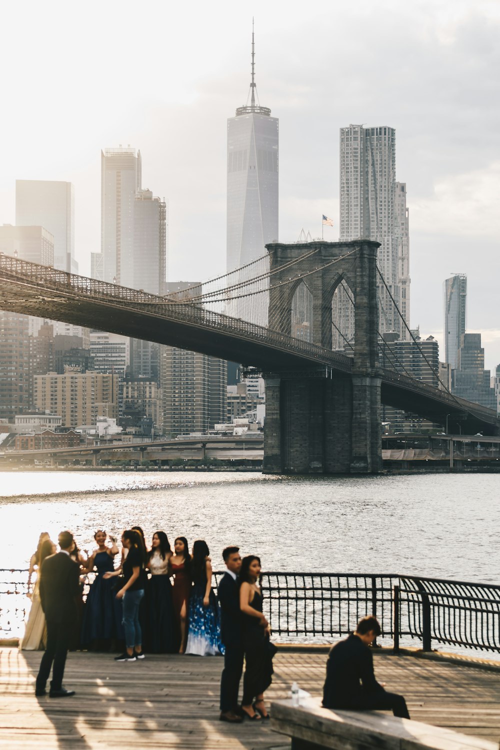 group of people near gray suspension bridge