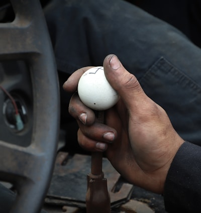 person holding white ball