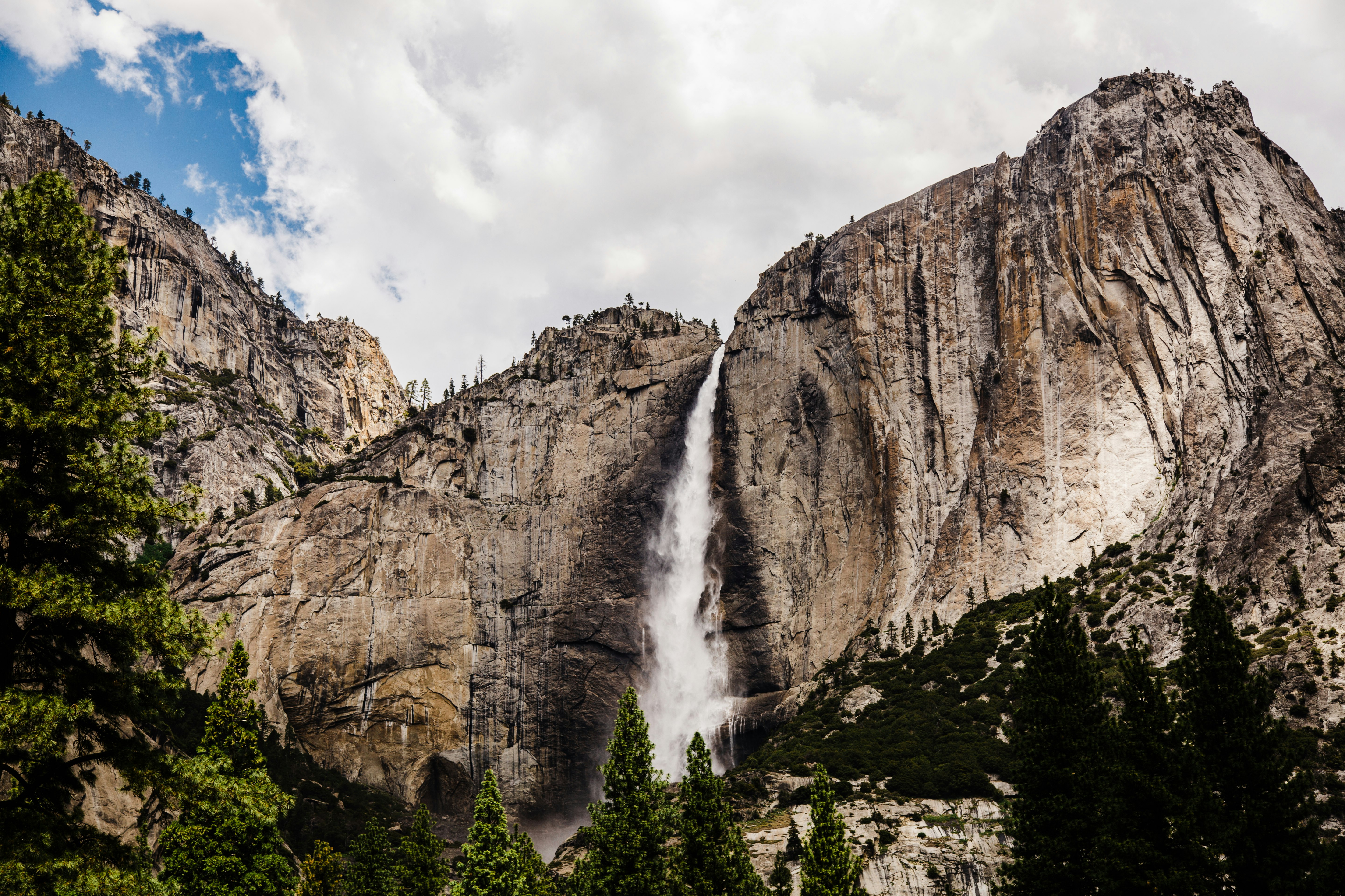 waterfalls under cloudy sky