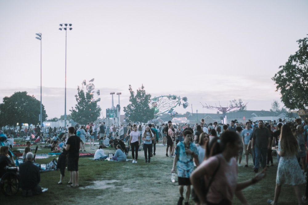 people standing on green grass field during daytime