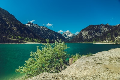 A serene landscape with mountains and a tranquil lake.