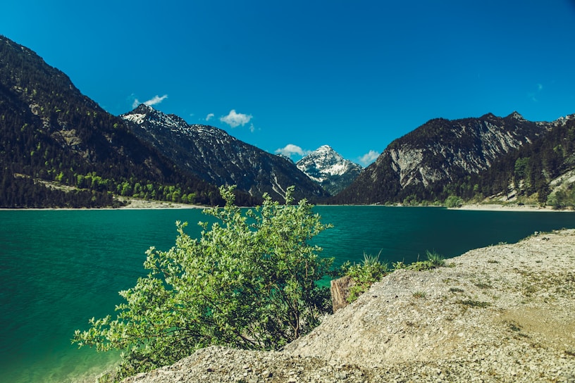 A serene landscape showcasing a tranquil lake surrounded by mountains.