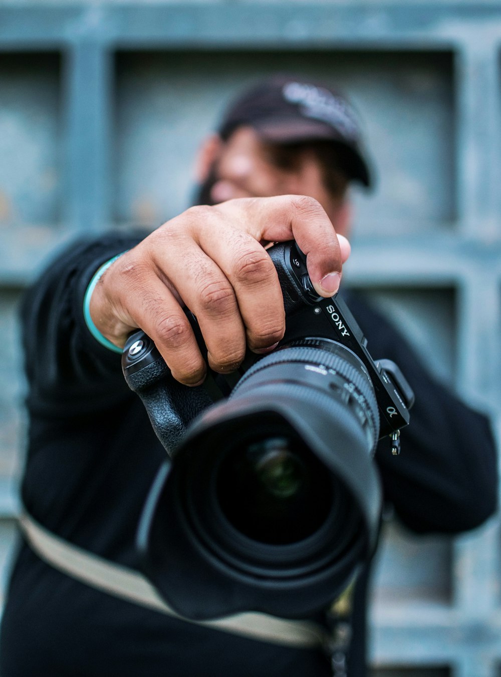 man holding Sony DSLR camera