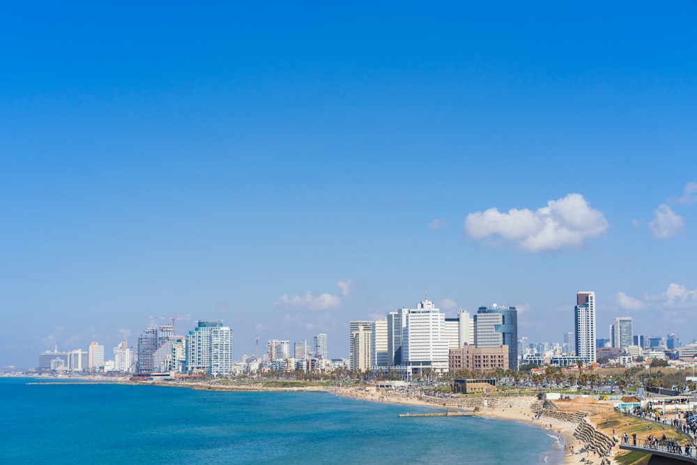 city skyline across blue sea under blue sky during daytime