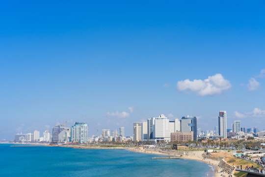 city skyline across blue sea under blue sky during daytime in Jaffa Israel