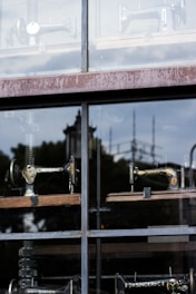 several sewing machine near glass window