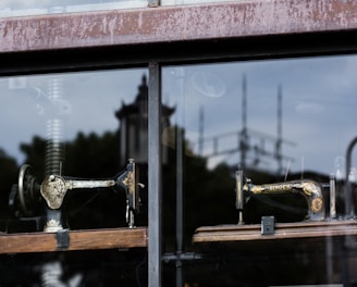 several sewing machine near glass window