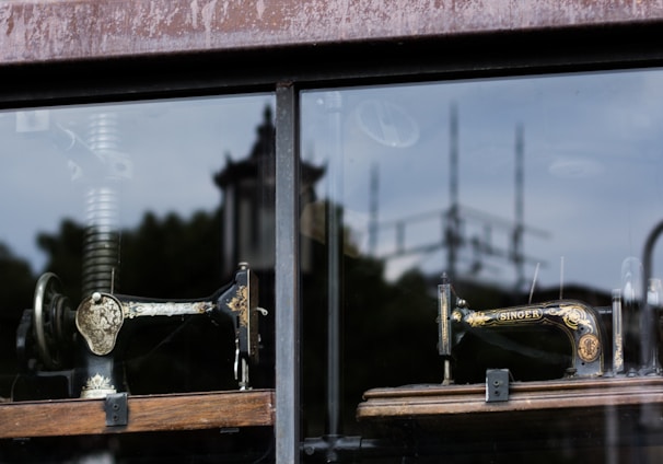 several sewing machine near glass window