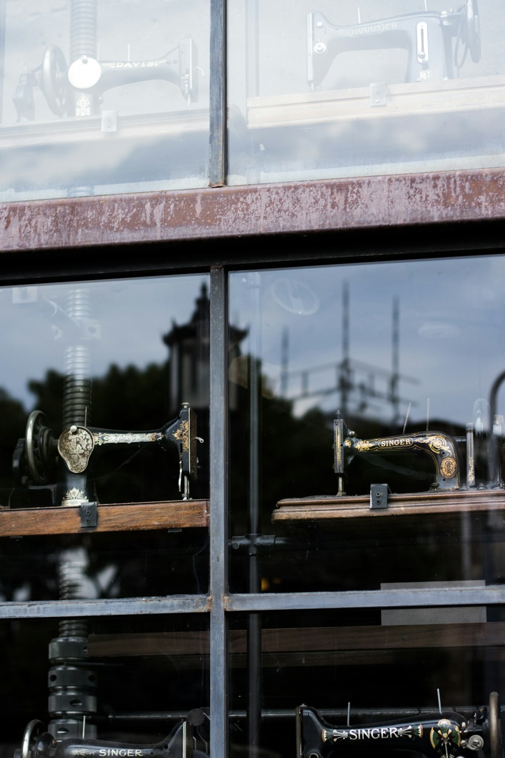 several sewing machine near glass window