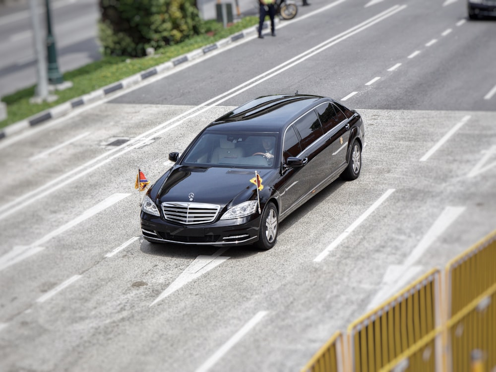 black Mercedes-Benz vehicle on road