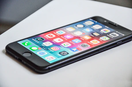 black iPhone 7 on white surface