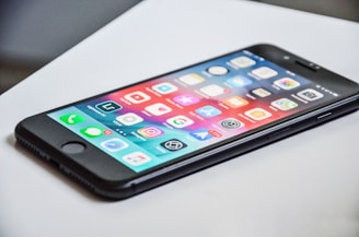 black iPhone 7 on white surface