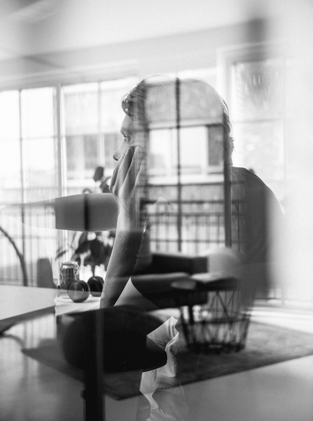 double exposure photo of man and black Ottoman chair