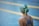 girl wearing swimsuit, swim cap, and swim goggles in front of swimming pool