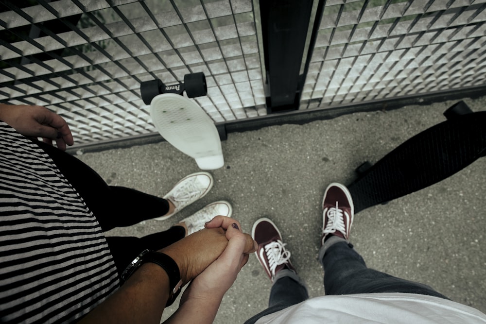 two people standing near fence