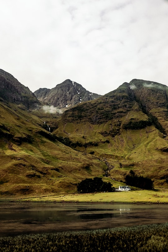 white house in foot of mountain at daytime in Glencoe United Kingdom