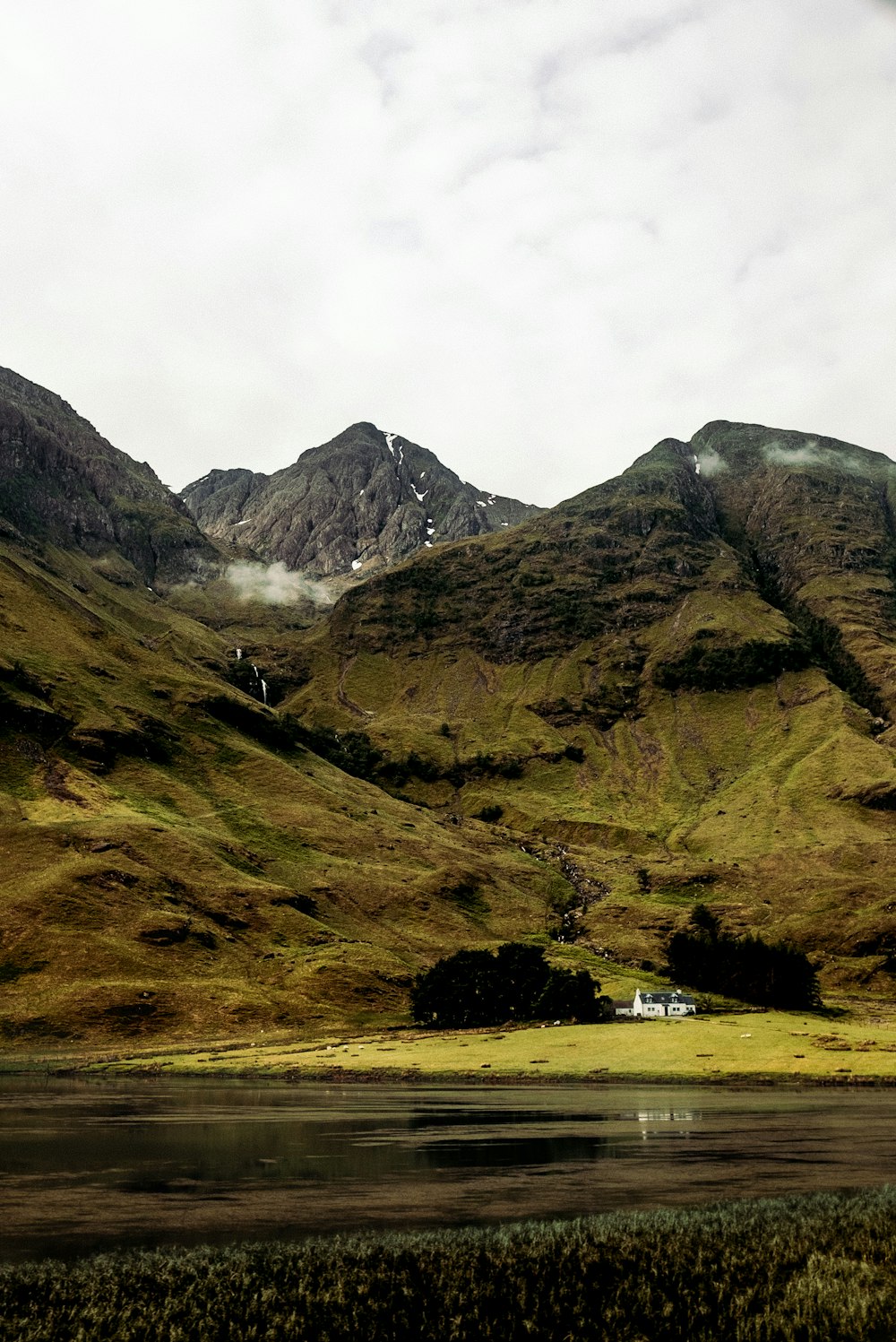 white house in foot of mountain at daytime