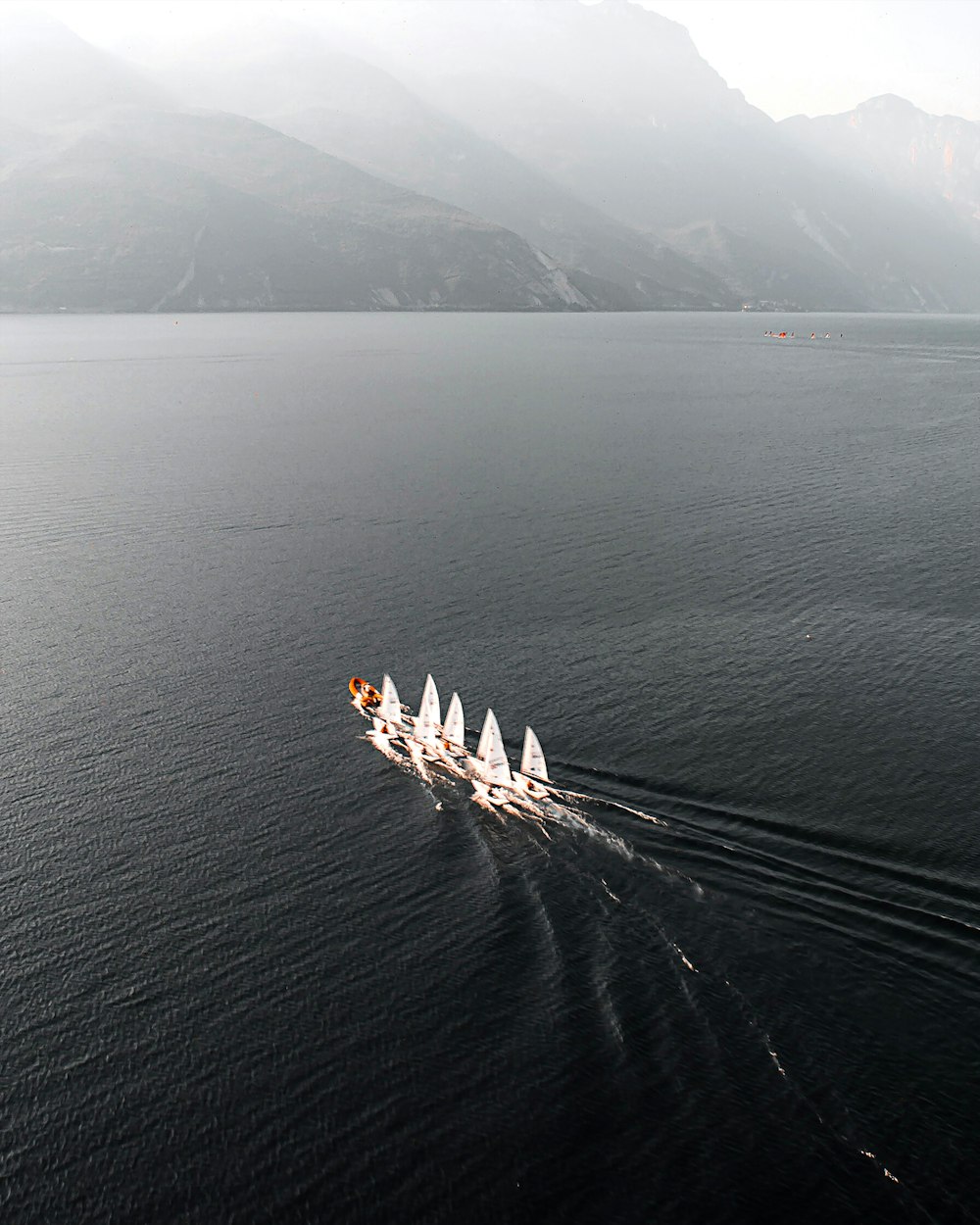 a group of boats sailing across a large body of water
