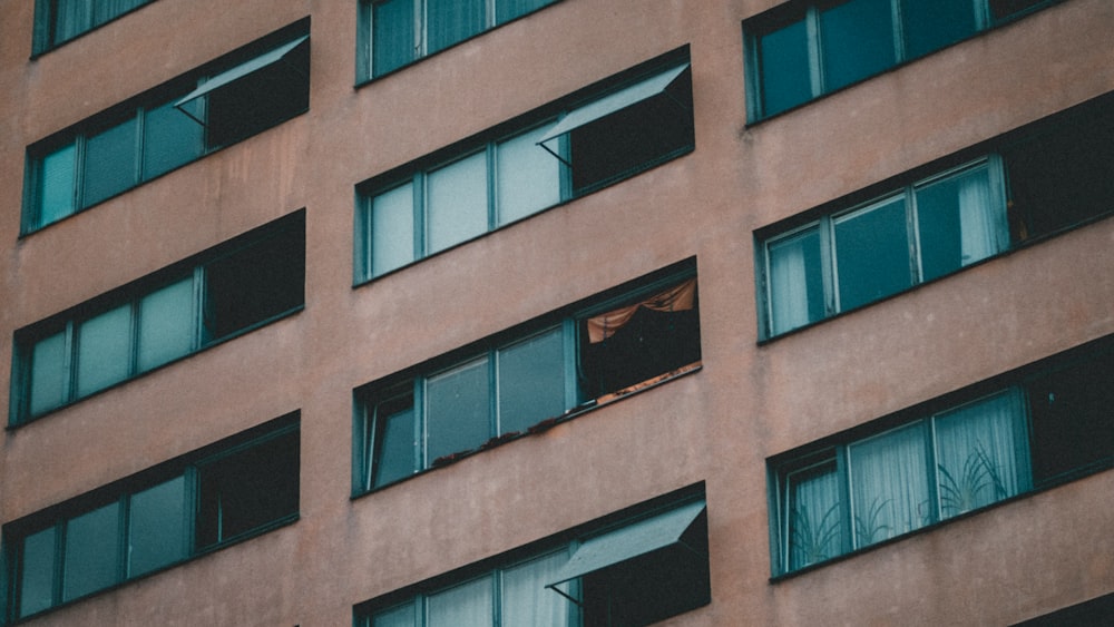 brown concrete building with glass windows