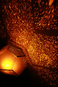 Bedroom featuring a glowing starry sky lamp creating a magical atmosphere.
