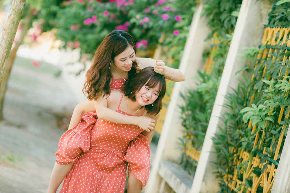 woman carrying another woman on her back