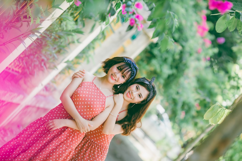 two women wearing polka-dot dresses