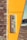 A silver intercom system is mounted on a bright yellow panel that is part of a building's exterior wall. The structure consists of light brown bricks on the left side. A white car is parked on a paved surface in the background.